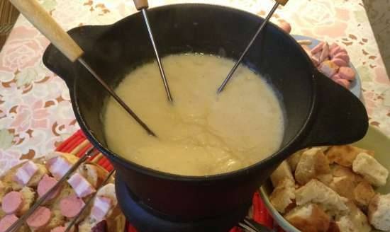 German fondue with smoked sausage, sausages and bacon.