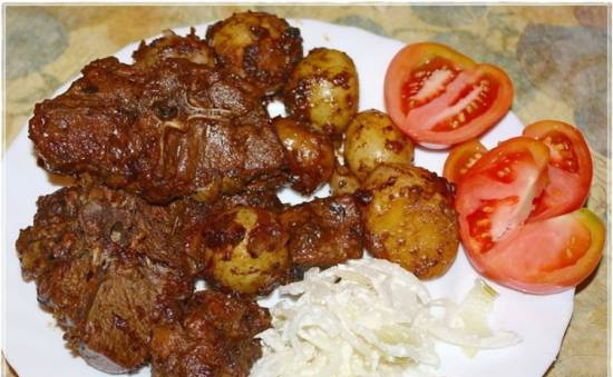 Lamb with fried potatoes in a cauldron