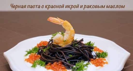 Black pasta with red caviar and crayfish oil under sour cream sauce