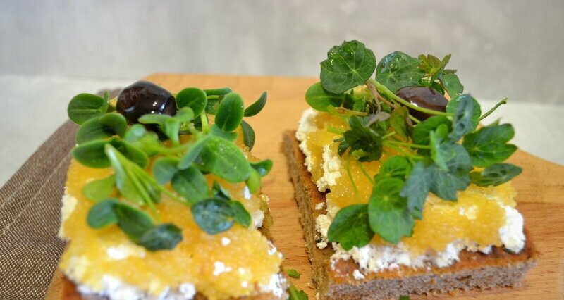 Curd snack with pike caviar and microgreens borago and nasturtium