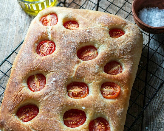 Focaccia with tomatoes on dough