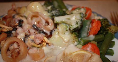 Seafood with vegetables and sauce in a double boiler