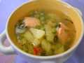 Salmon soup with green peas in chicken broth