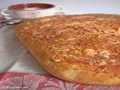 Potato focaccia with cheese and baked garlic